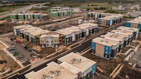Aerial photo of several multifamily buildings under construction.