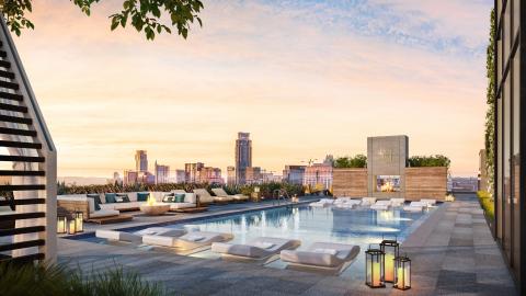 Rendering of a the rooftop of a tall building showing pool and other amenities, with a group of tall and midsized building on the horizon